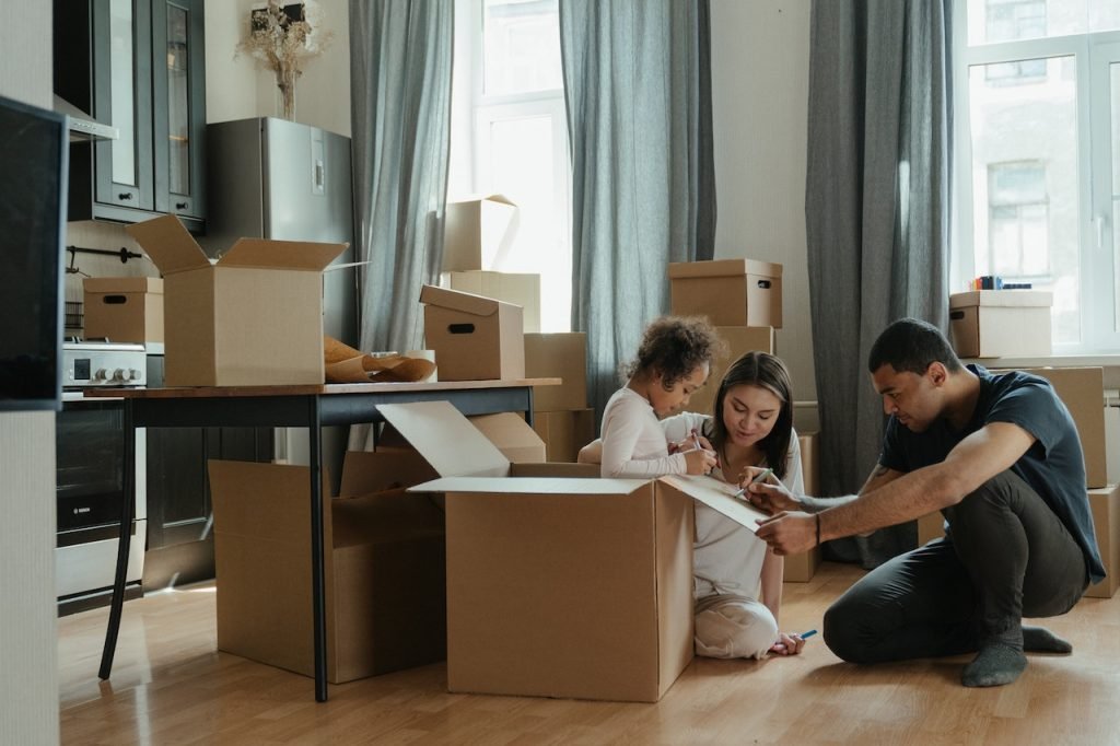 A family labeling every box before moving.