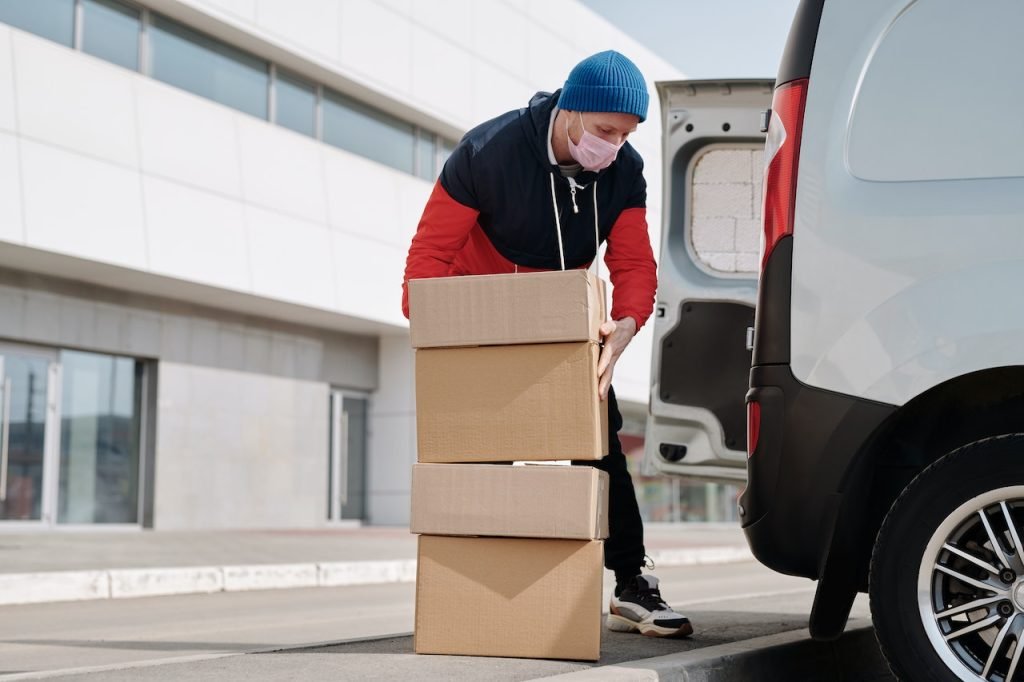 A man loading boxes into his car.