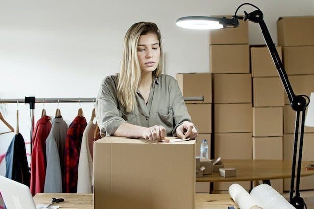 A woman packing a box